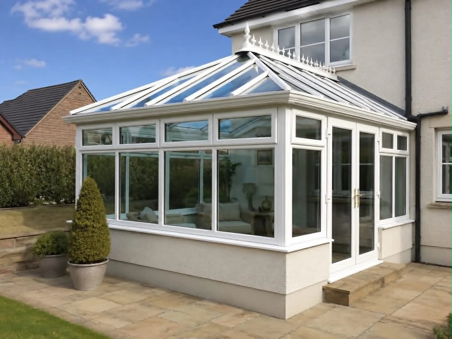 Clean white conservatory exterior and glass roof at a home in Ballymoney
